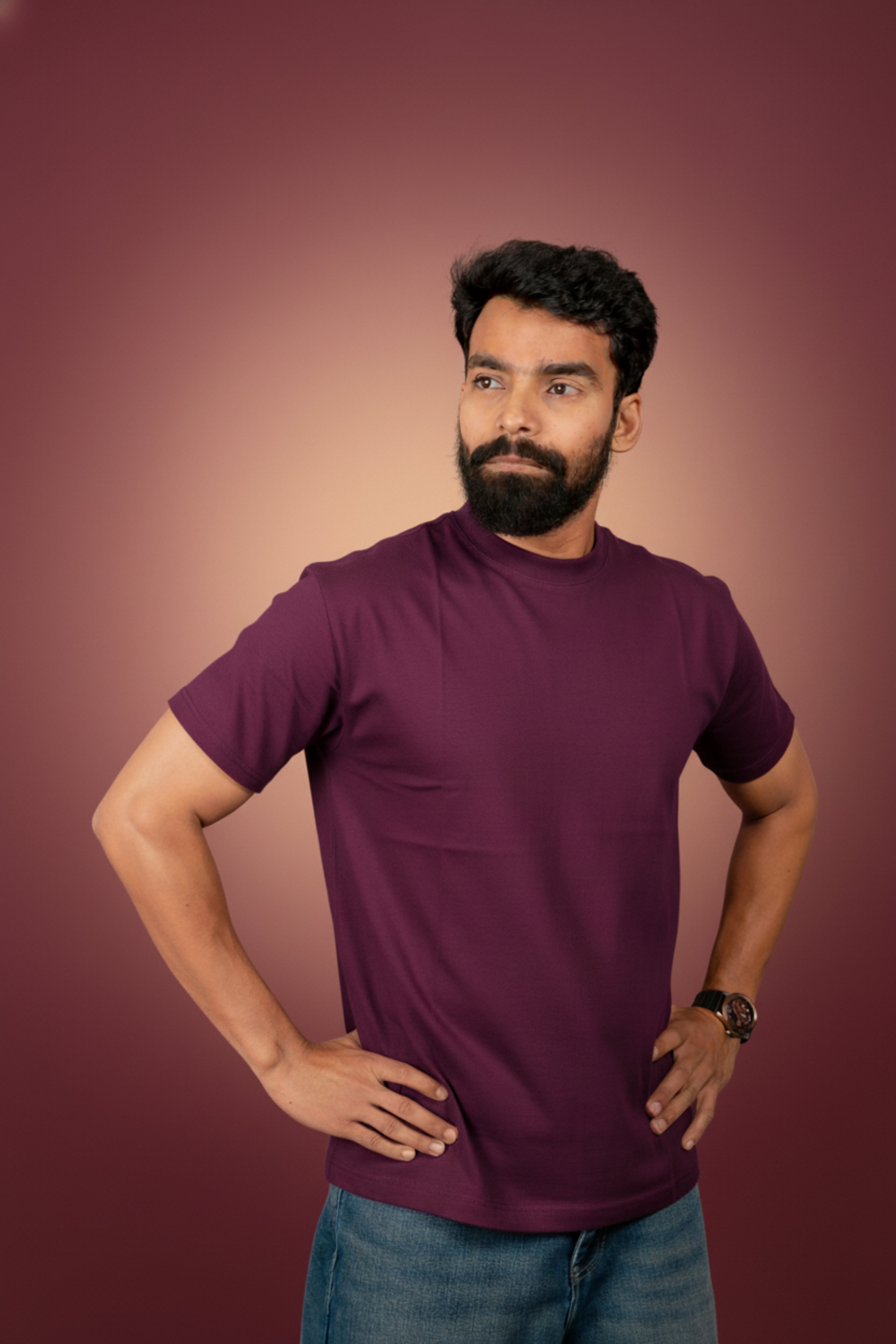 Man wearing a purple turtleneck shirt against a blue background