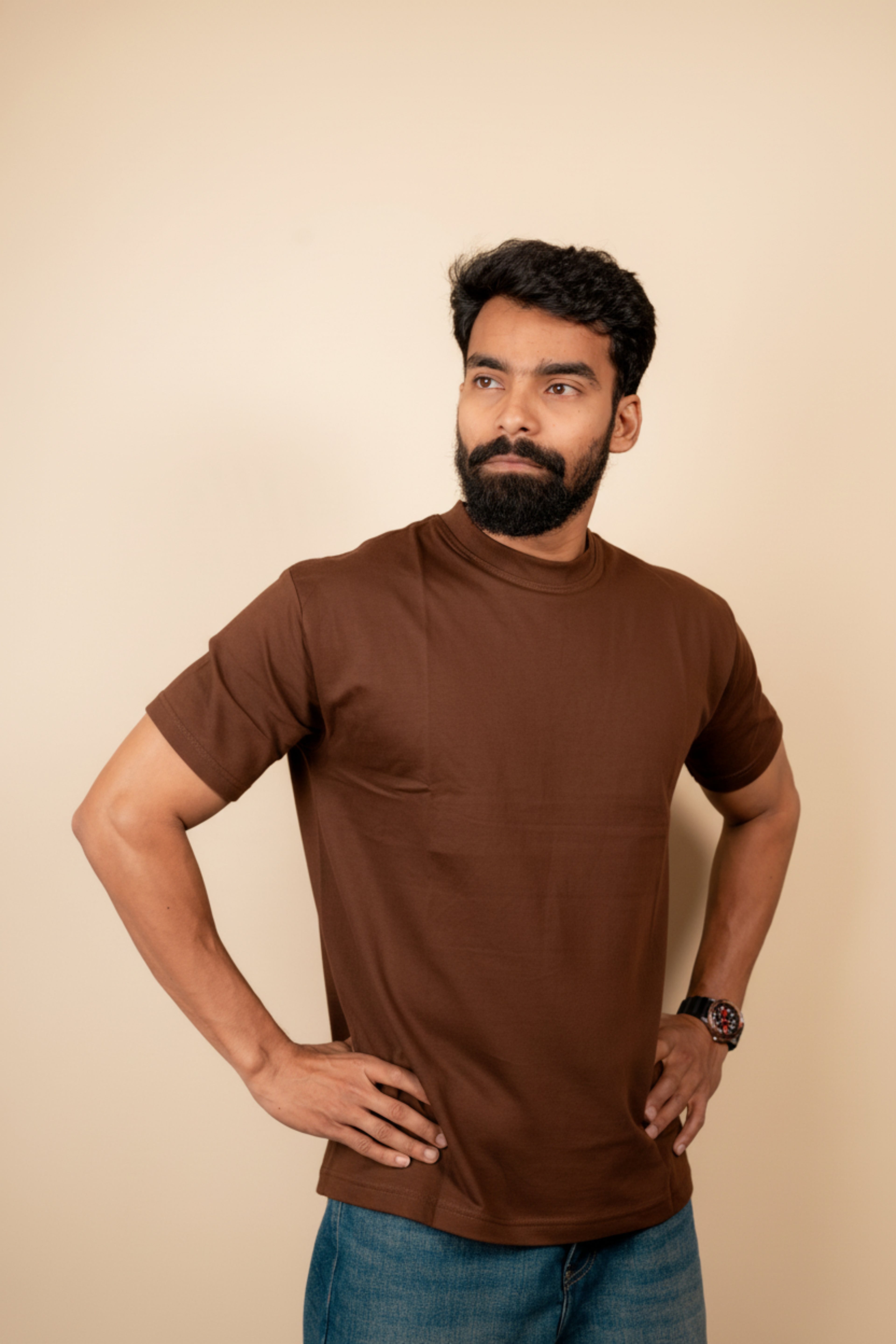 Man wearing a Chocolate Brown turtleneck shirt against a blue background