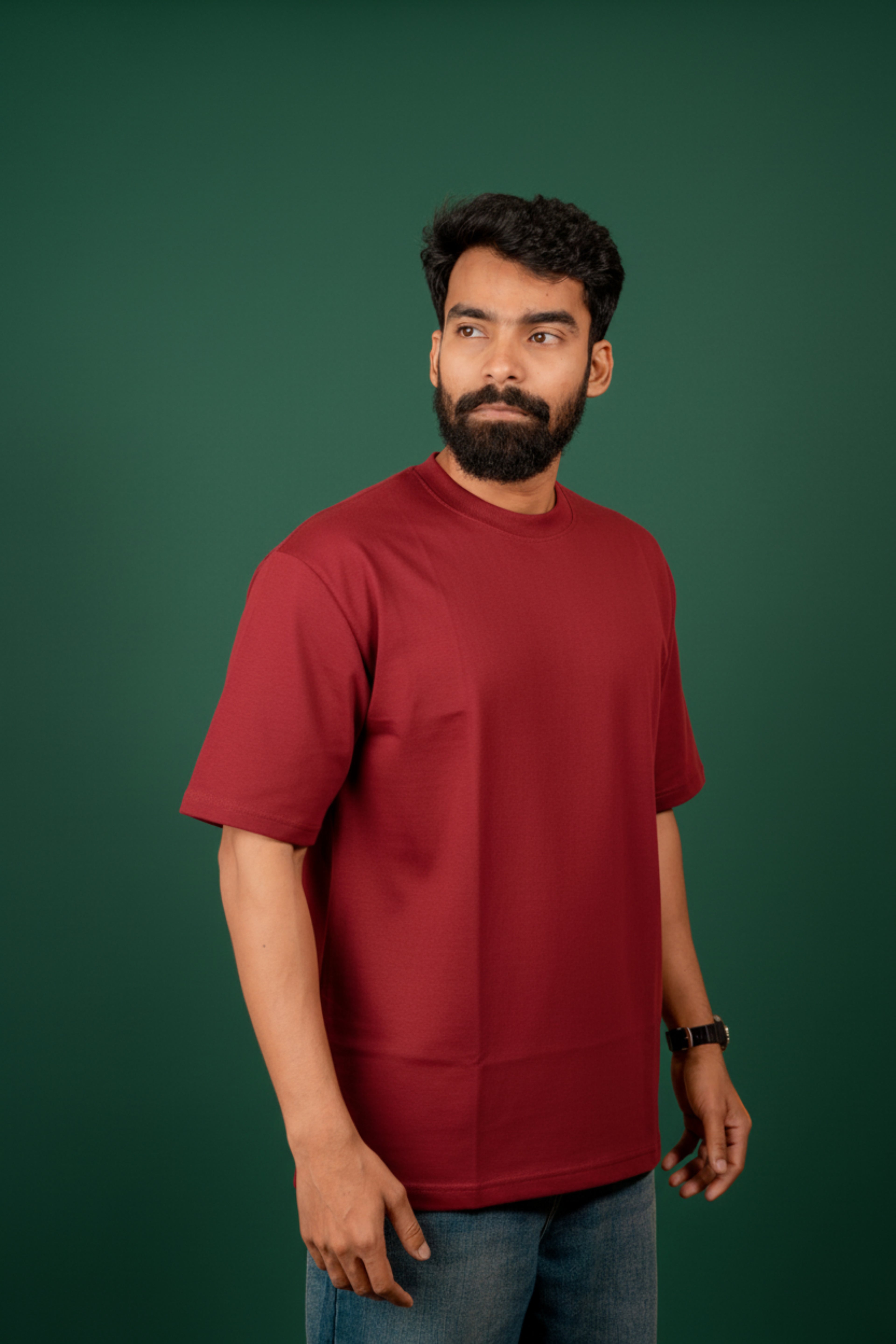 Man wearing a Red t-shirt against a beige background